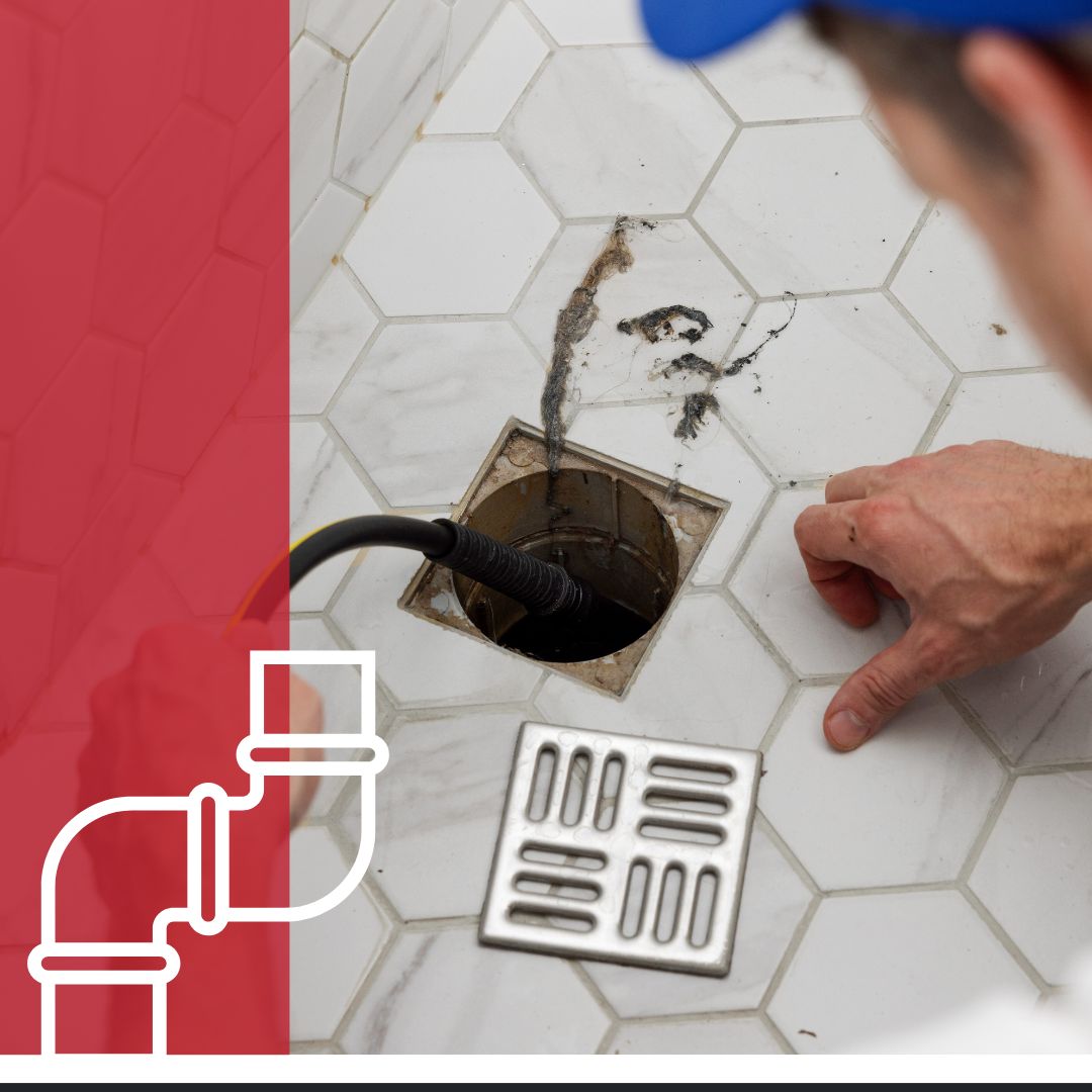 plumber jetting gunk out of shower drain