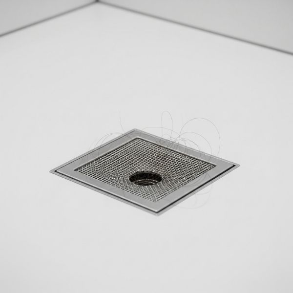 A shower drain with a hair catcher installed to prevent clogs.