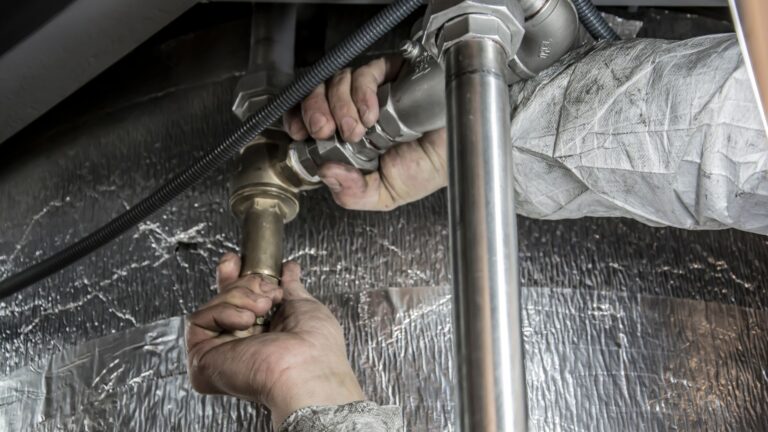 person holding drain pipes with their hands