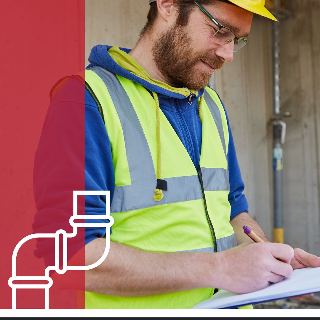 professional plumber writes estimate on clipboard