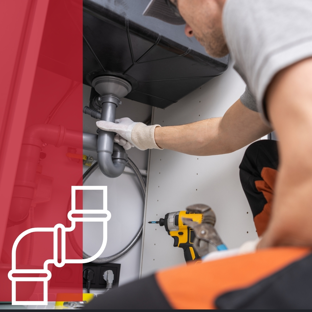 Plumber working on pipes