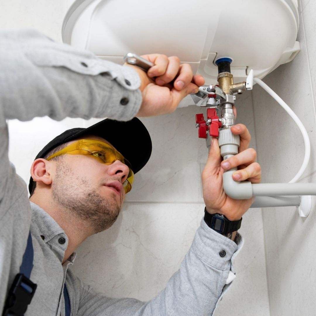 plumber working underneath a sink